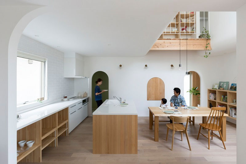 A warm and inviting Japanese home featuring beautiful arched doorways, soft natural light, and a simple wood-toned interior that creates a cozy and timeless atmosphere.