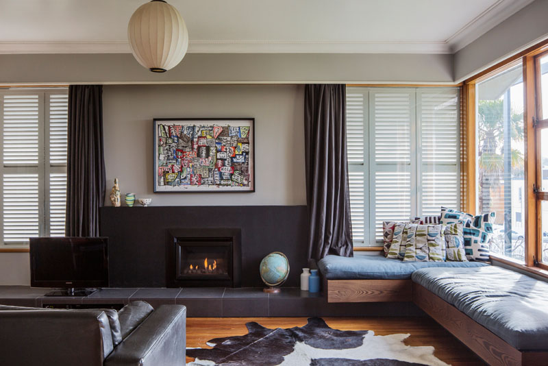 Built-in window seat offers the perfect nook for daydreaming in this airy 1960s living room.