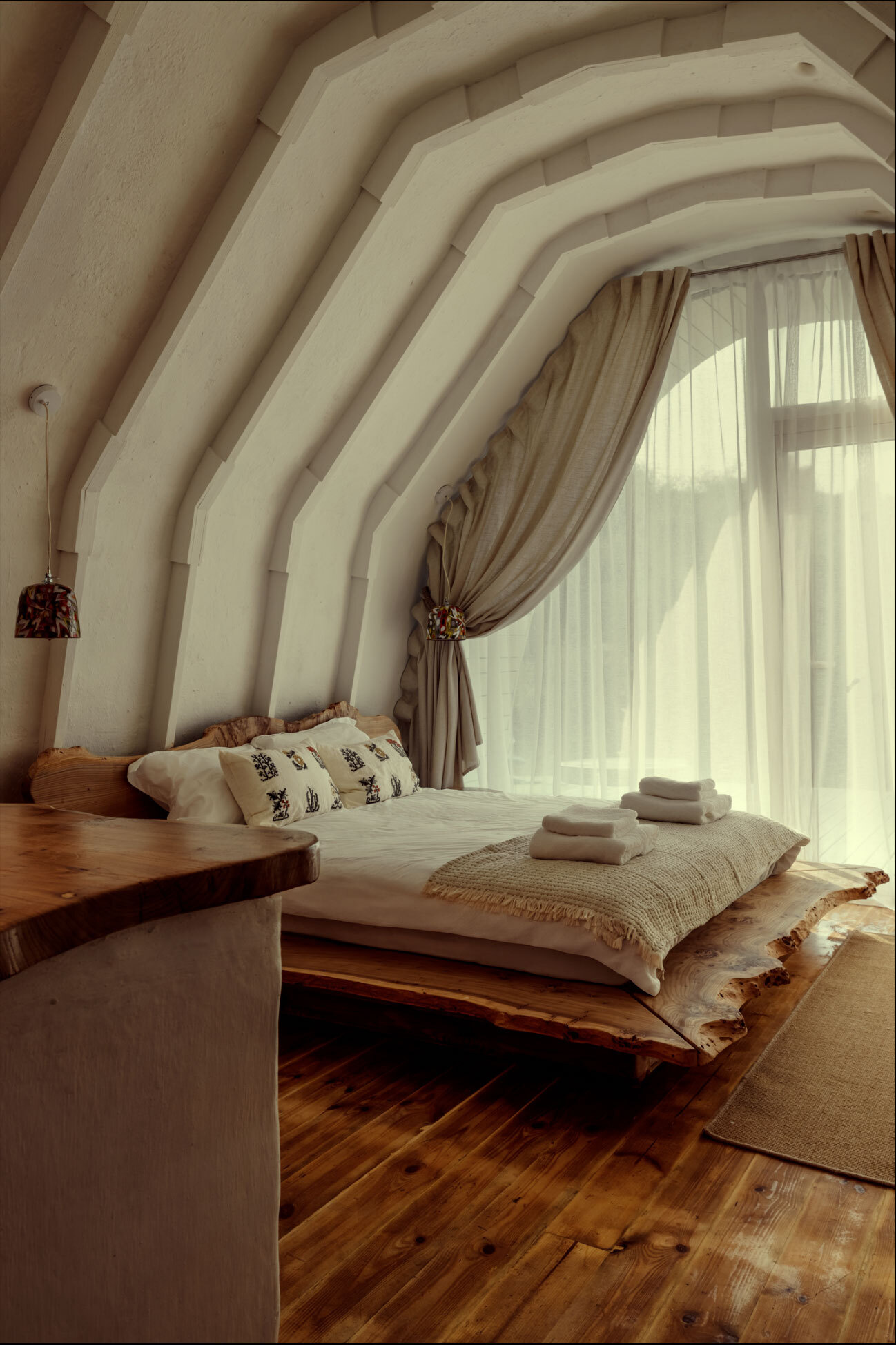 A hobbit-inspired cabin built-into the earth, includes a bedroom, kitchen, and bathroom.
