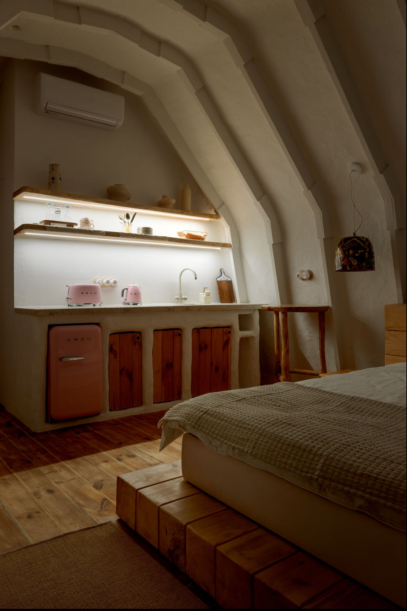A hobbit-inspired cabin built-into the earth, includes a bedroom, kitchen, and bathroom.