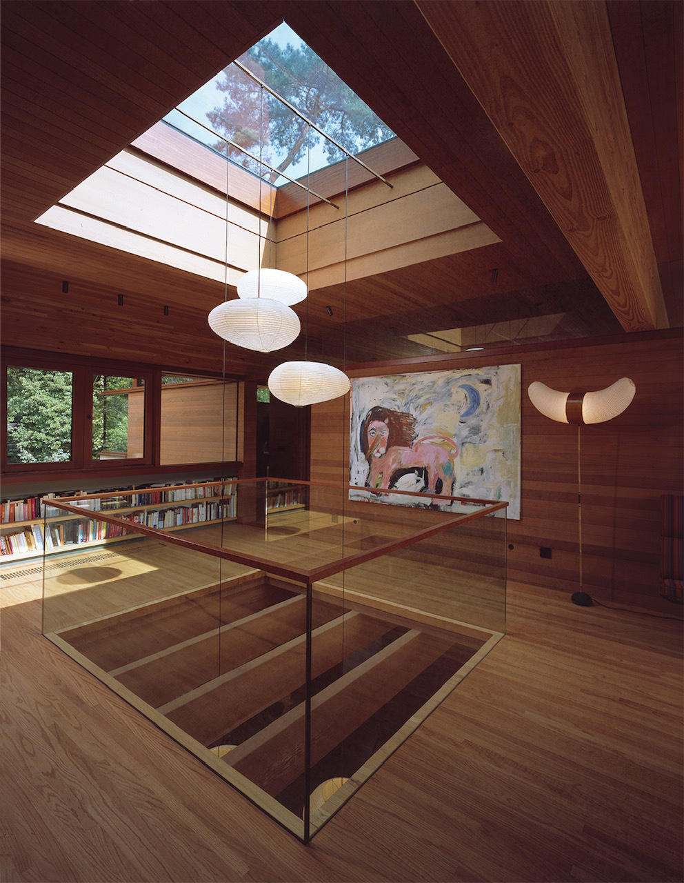 A skylight draws daylight deep into the home, shifting in mood with the passing hours. This natural illumination reduces the need for artificial light and enhances the sense of openness that defines the residence.