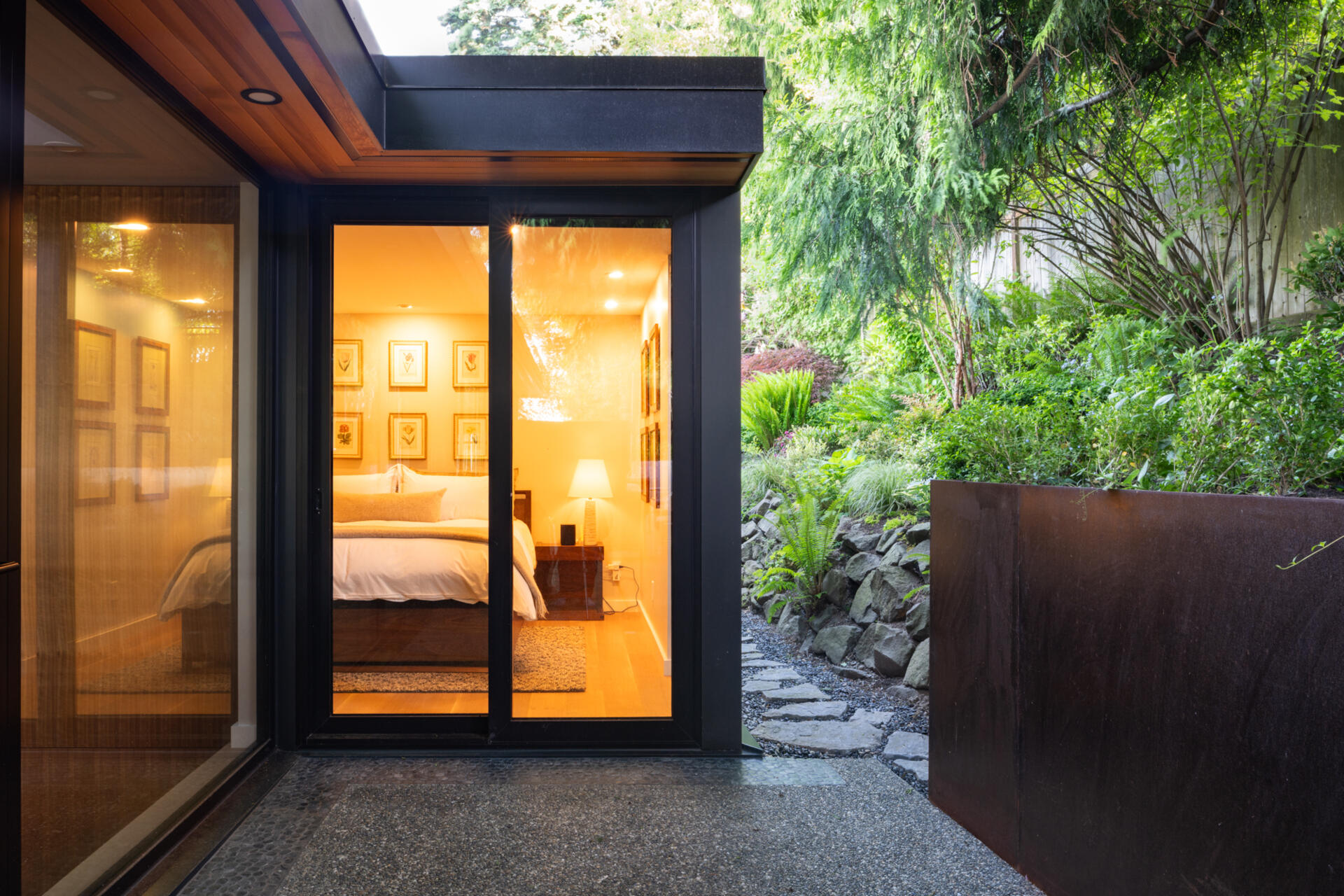 This bedroom has a sliding glass door that opens to a small patio.