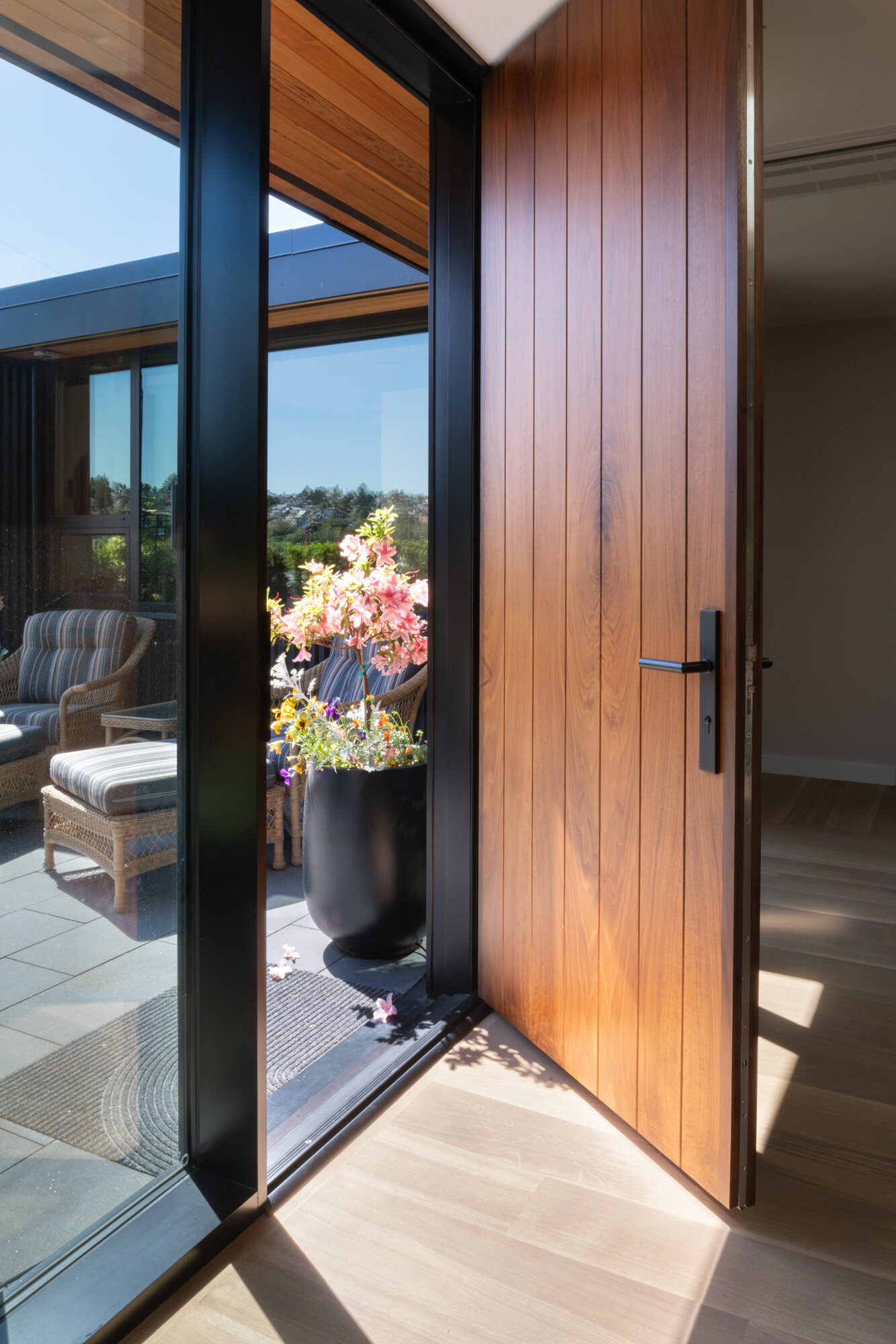 Approaching the front door, the dark wood tones and crisp lines create a sense of drama while still feeling grounded in natural materials. This entry point sets the stage for the careful blend of vintage warmth and modern precision carried throughout the home.