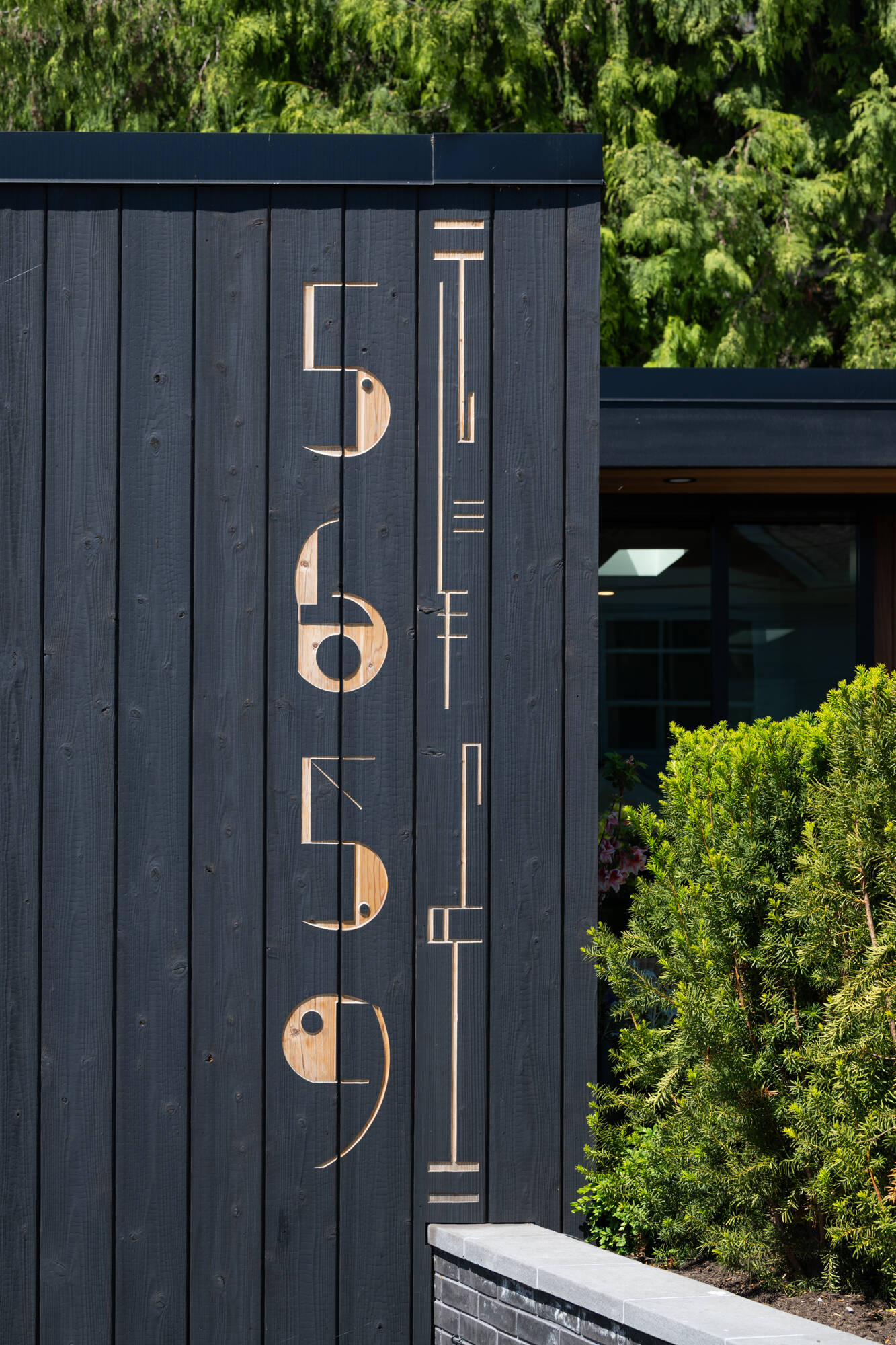 A small but eye-catching detail sits right at the entrance to this renovated mid-century modern home, where custom house numbers were milled them directly into the siding