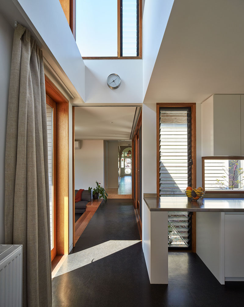 A sleek hallway links the heritage home with its modern extension, creating a smooth architectural transition.