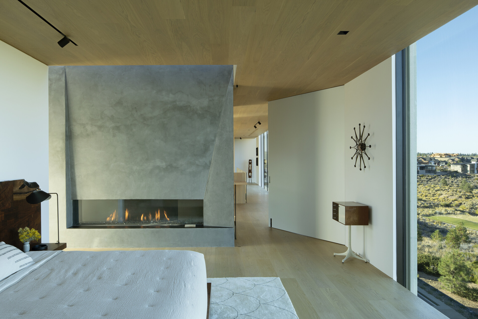 This upper-level primary suite, with its own fireplace, blends privacy with panoramic views. Perched above the main living areas, it offers a peaceful retreat while maintaining a strong connection to the surrounding desert.