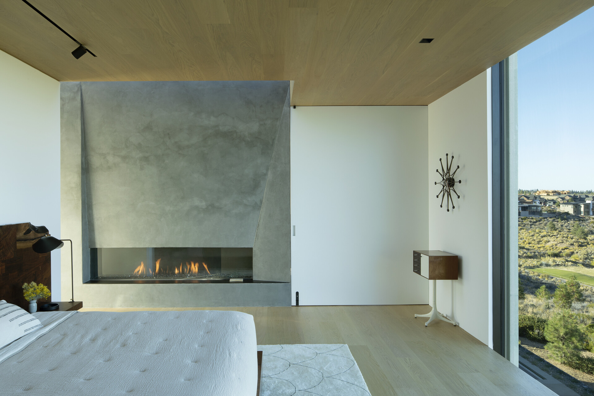This upper-level primary suite, with its own fireplace, blends privacy with panoramic views. Perched above the main living areas, it offers a peaceful retreat while maintaining a strong connection to the surrounding desert.