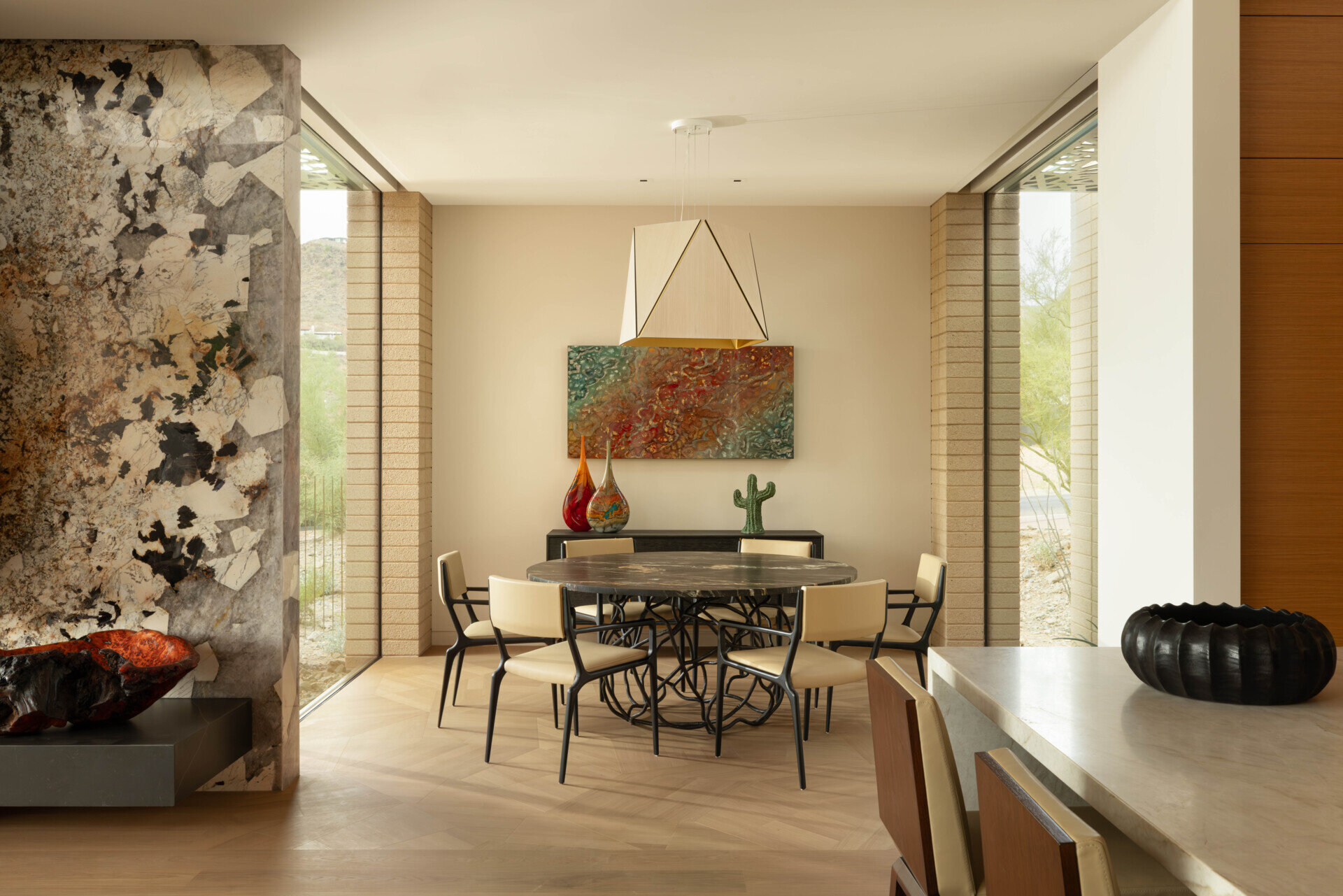 Intimate dining areas are strategically placed to connect with both indoor and outdoor environments. The interplay of light through patterned screens adds texture to mealtime settings.
