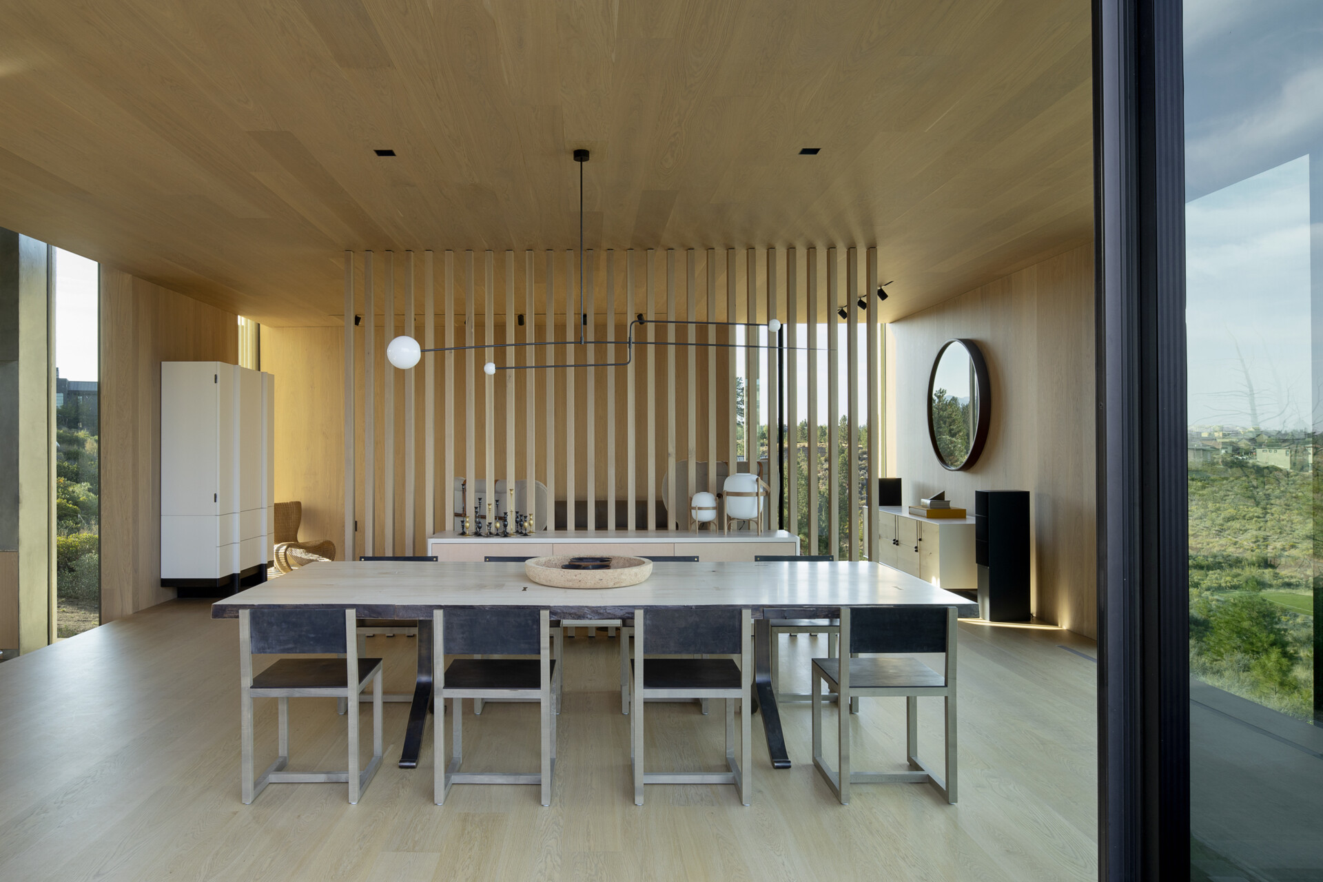 A few steps above the kitchen, the dining room sits in its own perched volume. Elevated and set apart, it enjoys sweeping views and a sense of occasion, making every meal feel like a special event.