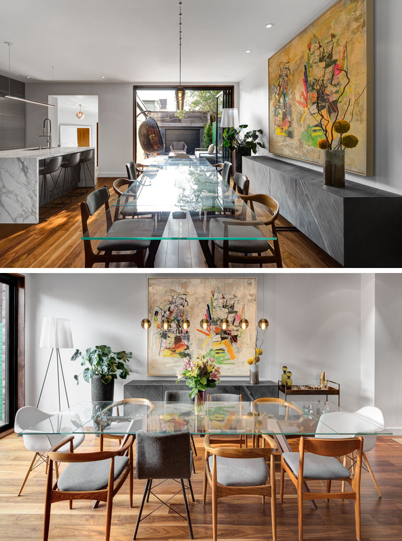A long glass dining table paired with mixed chairs and sleek storage makes this dining room feel stylish yet welcoming.