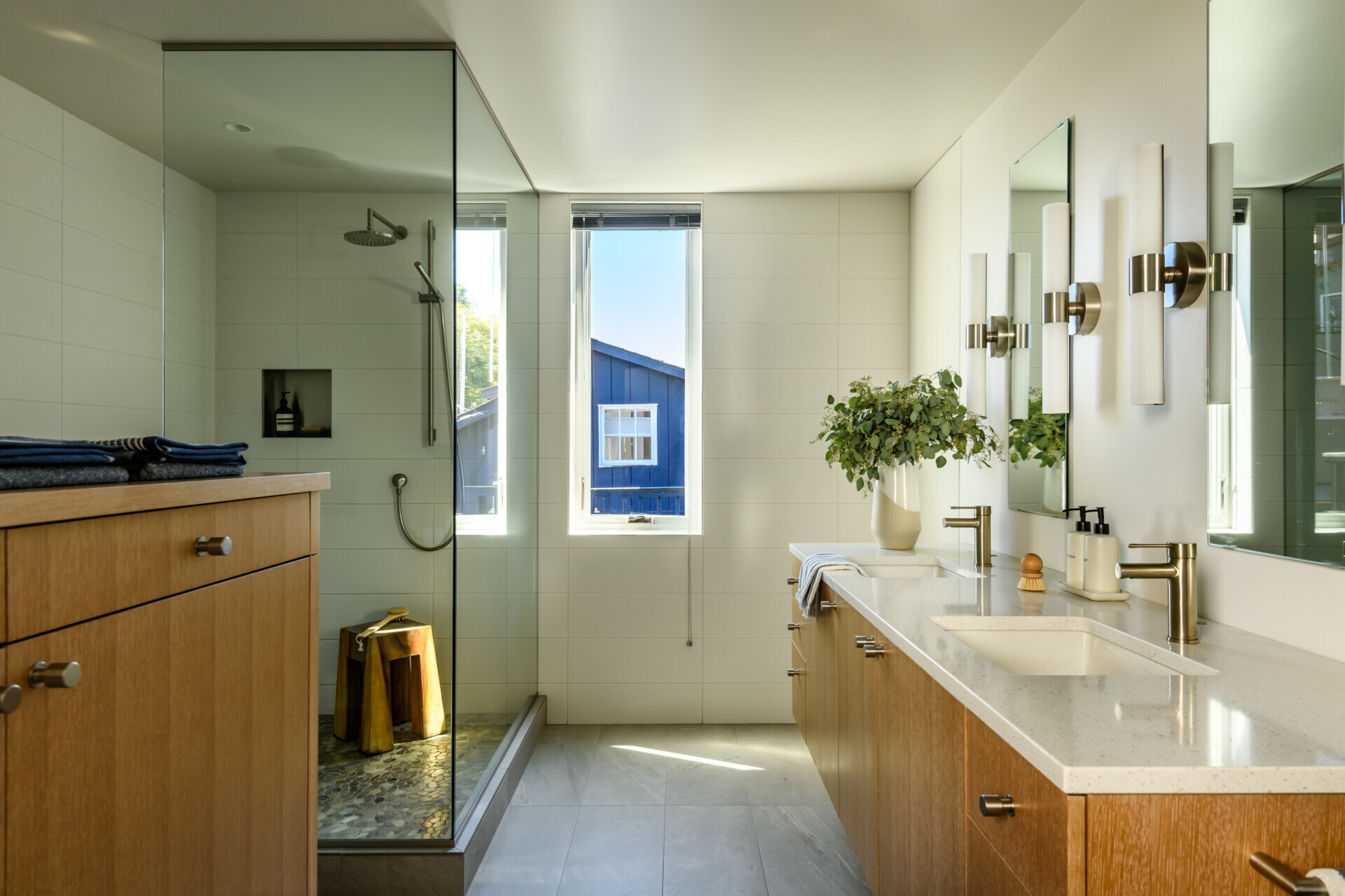 Built-in cabinetry that continues through to the bathroom adds plenty of storage, while a glass-enclosed shower and vanity complete the bathroom.