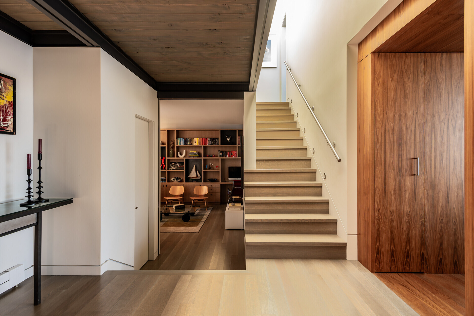 Wood stairs lead upward through this float home, while skylights above fill the interior with natural light and connect the levels with a sense of openness.
