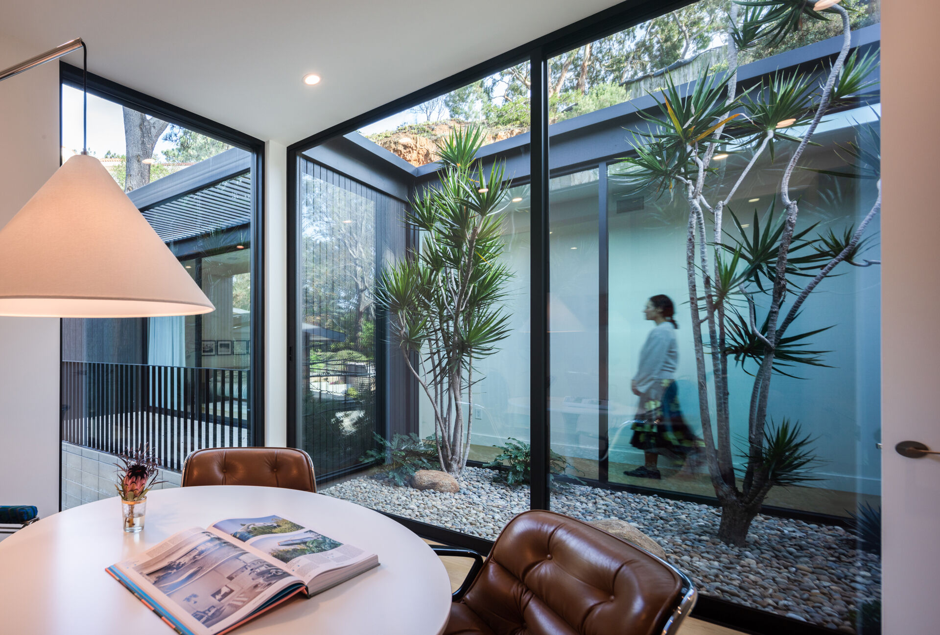 A dedicated home office enjoys abundant natural light and calming views of a small garden.