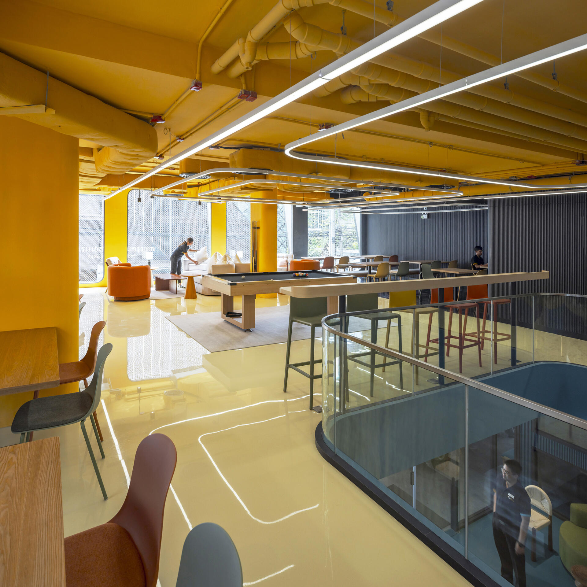 A dynamic social space where bold colors, patterns, and flexible zones encourage guests to eat, work, relax, or play, all in one stylish setting.