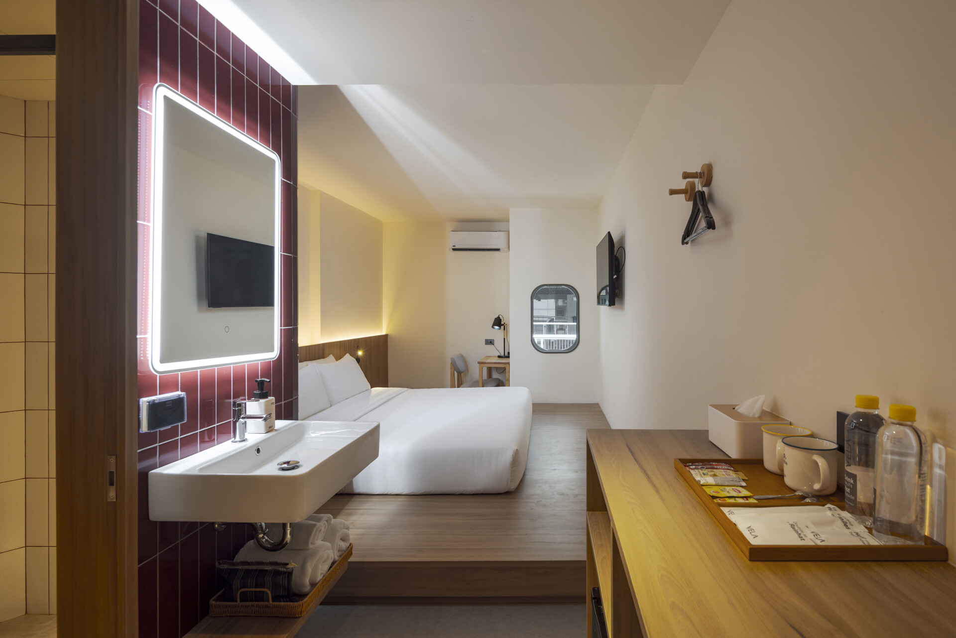 Muted tones create a peaceful mood inside the rooms, while fun design moments like colorful bathroom tiles add an unexpected twist to the calm.