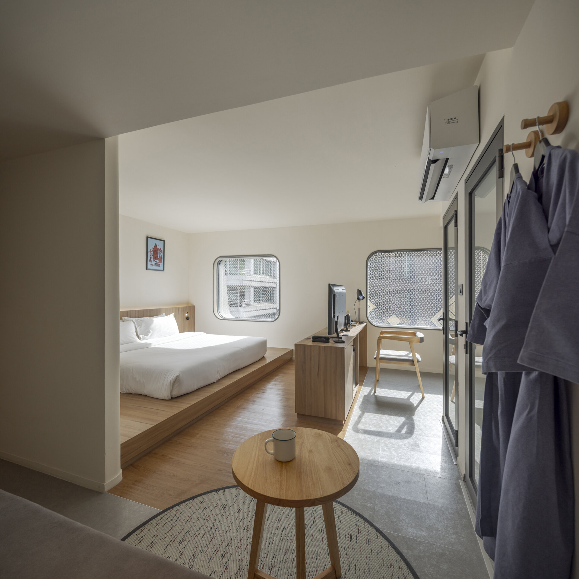 Muted tones create a peaceful mood inside the rooms, while fun design moments like colorful bathroom tiles add an unexpected twist to the calm.
