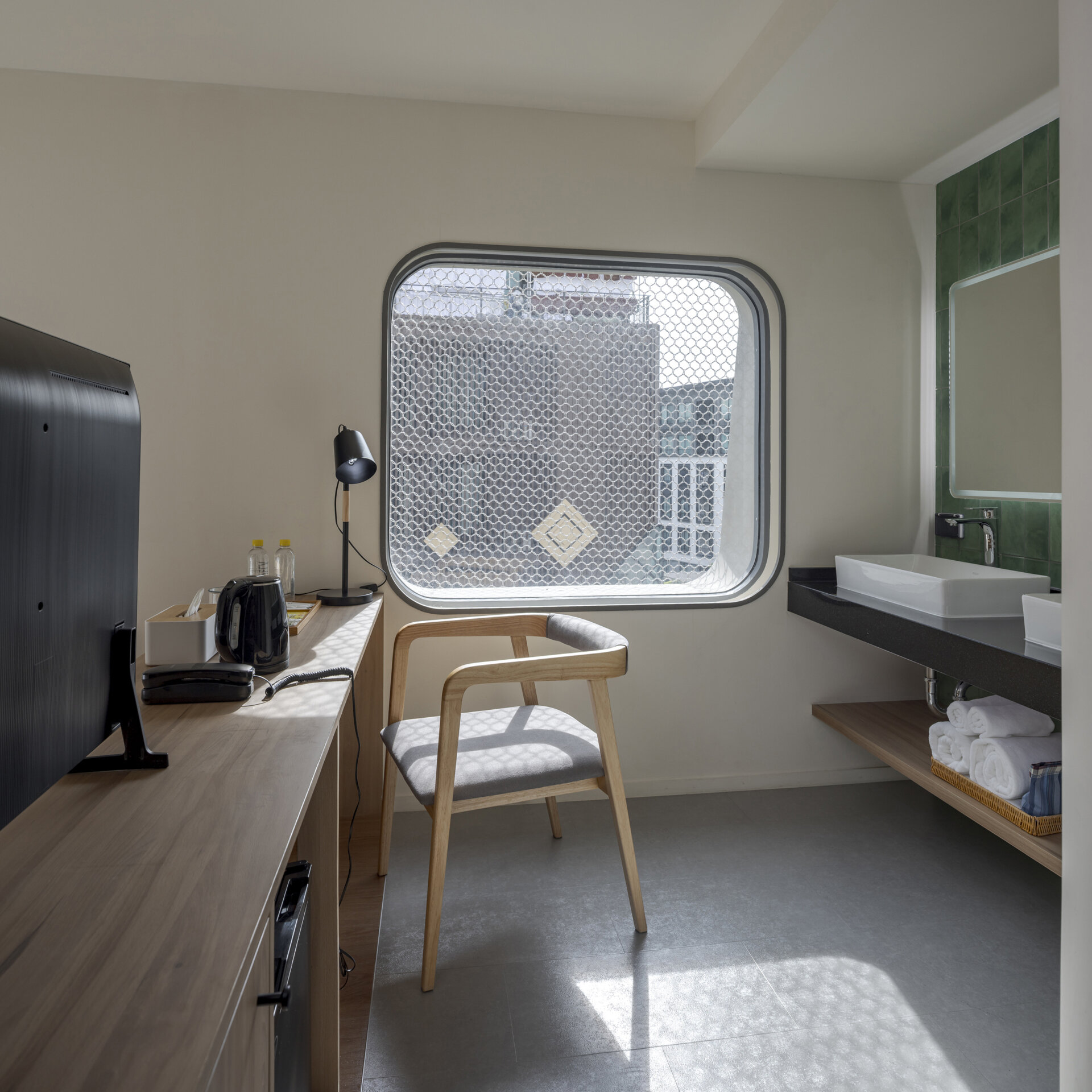 Muted tones create a peaceful mood inside the rooms, while fun design moments like colorful bathroom tiles add an unexpected twist to the calm.