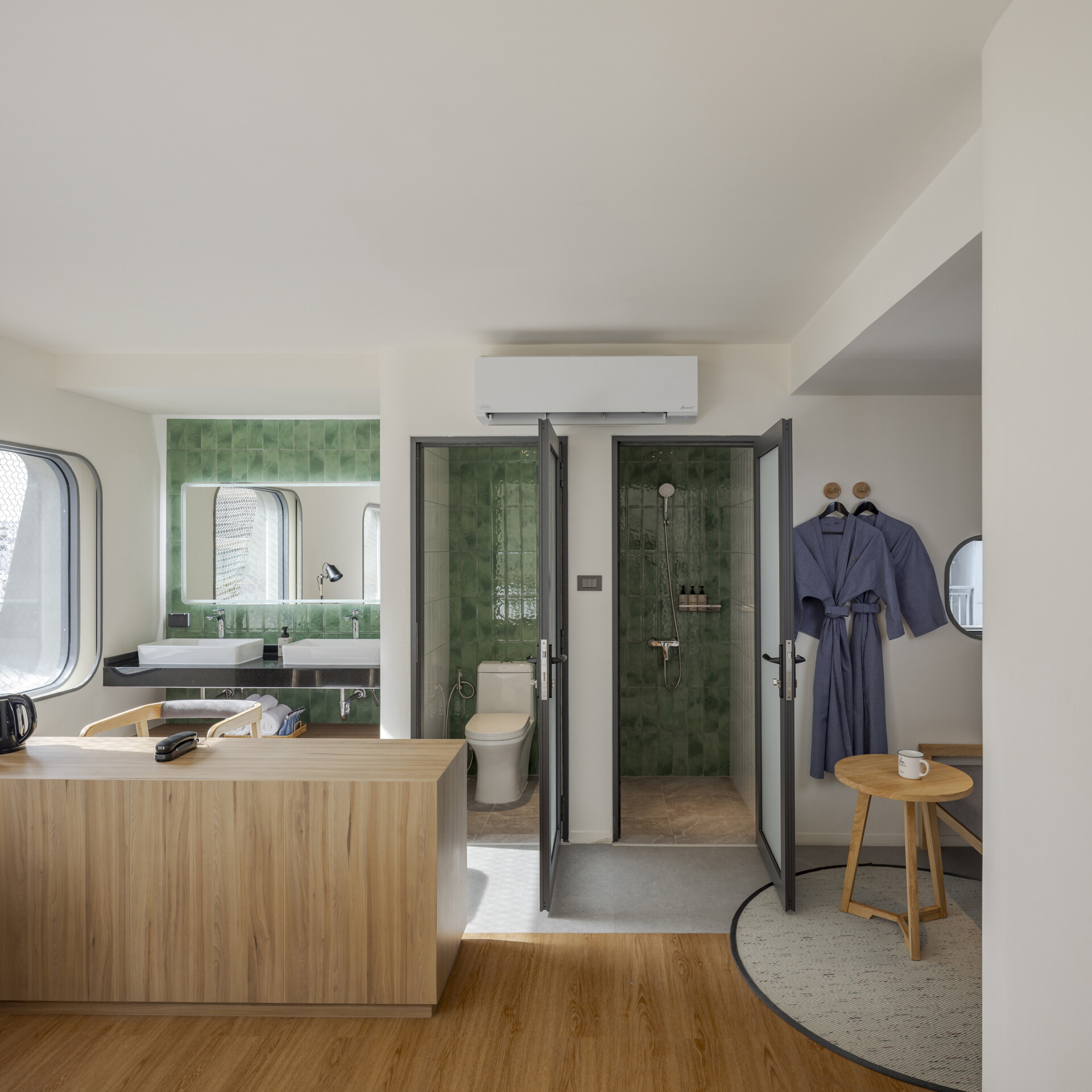 Muted tones create a peaceful mood inside the rooms, while fun design moments like colorful bathroom tiles add an unexpected twist to the calm.