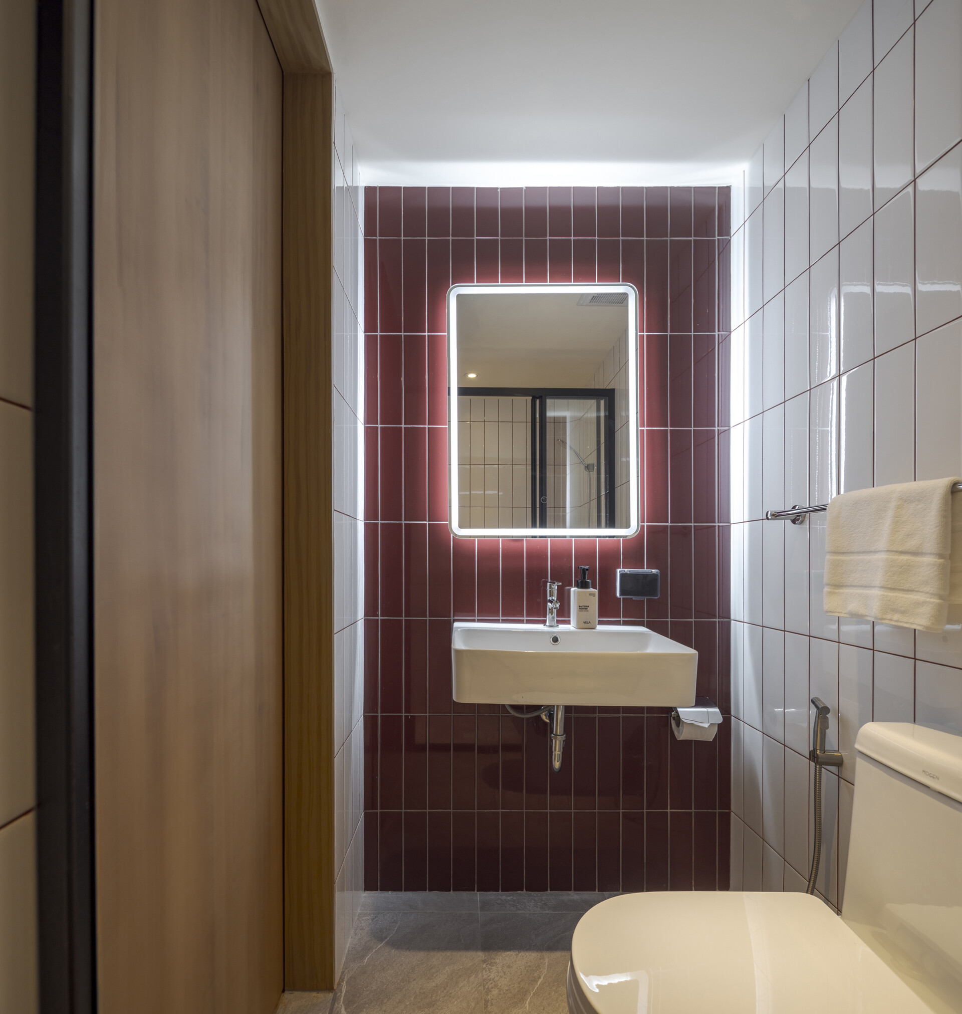 Muted tones create a peaceful mood inside the rooms, while fun design moments like colorful bathroom tiles add an unexpected twist to the calm.