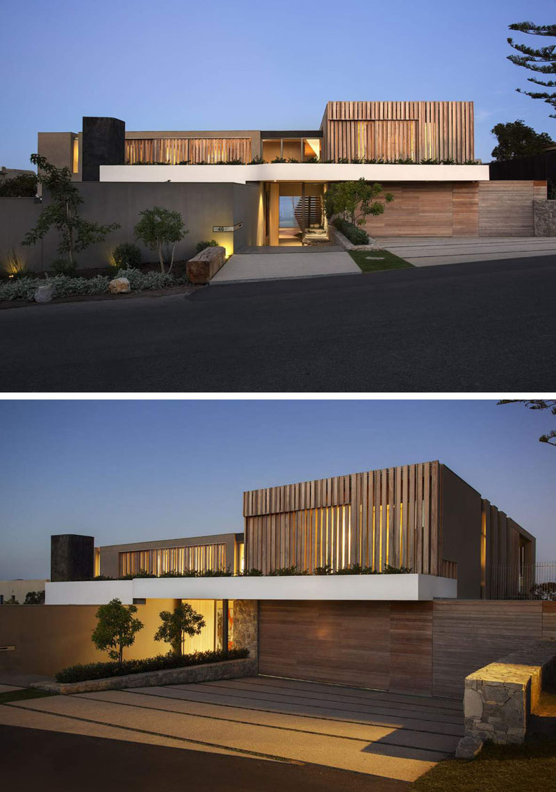 From the street, this home feels understated, blending wood, white, and gray tones with the surrounding greenery.
