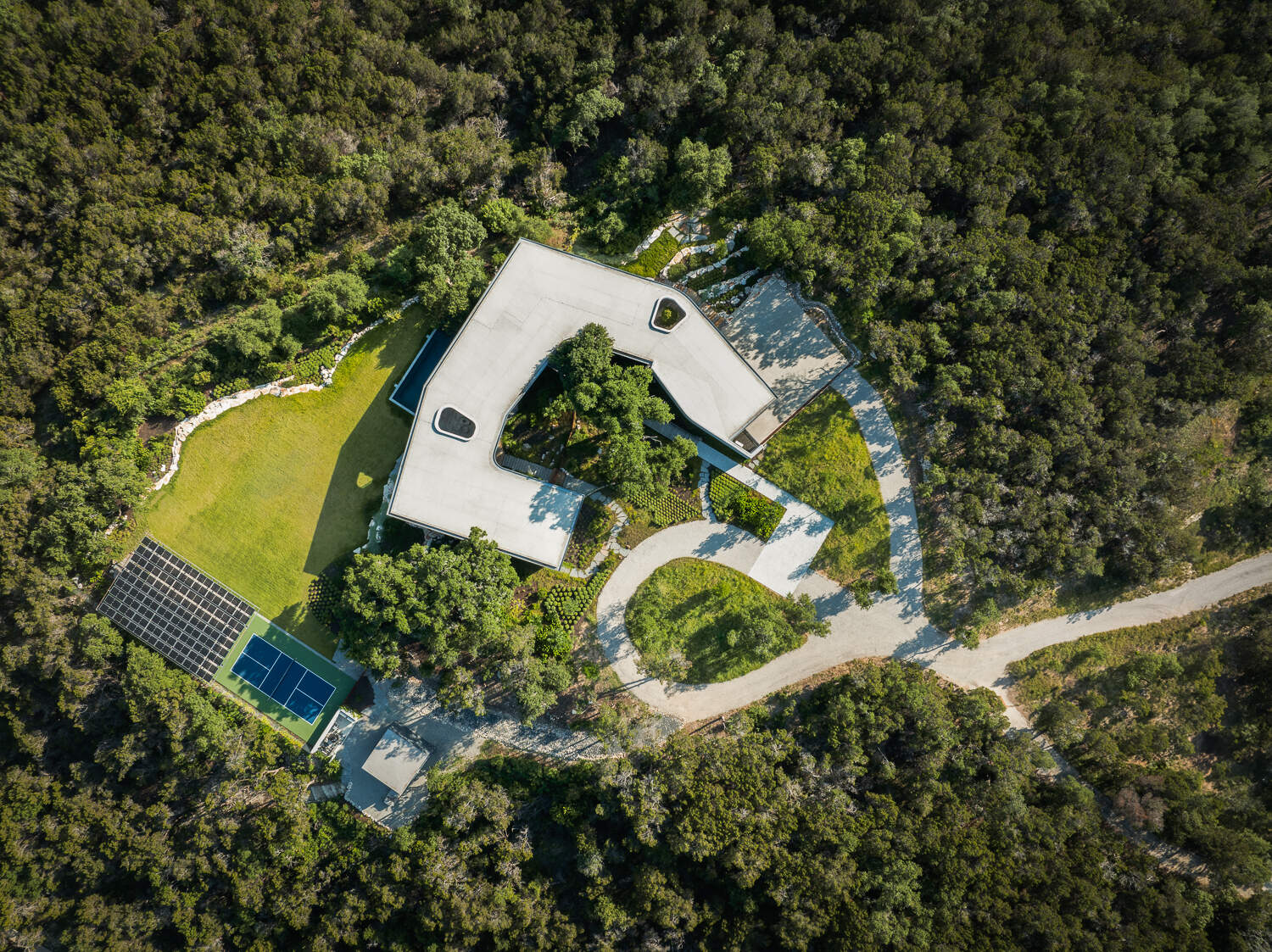 Natural stone, wood, and steel define this sustainable hillside home.