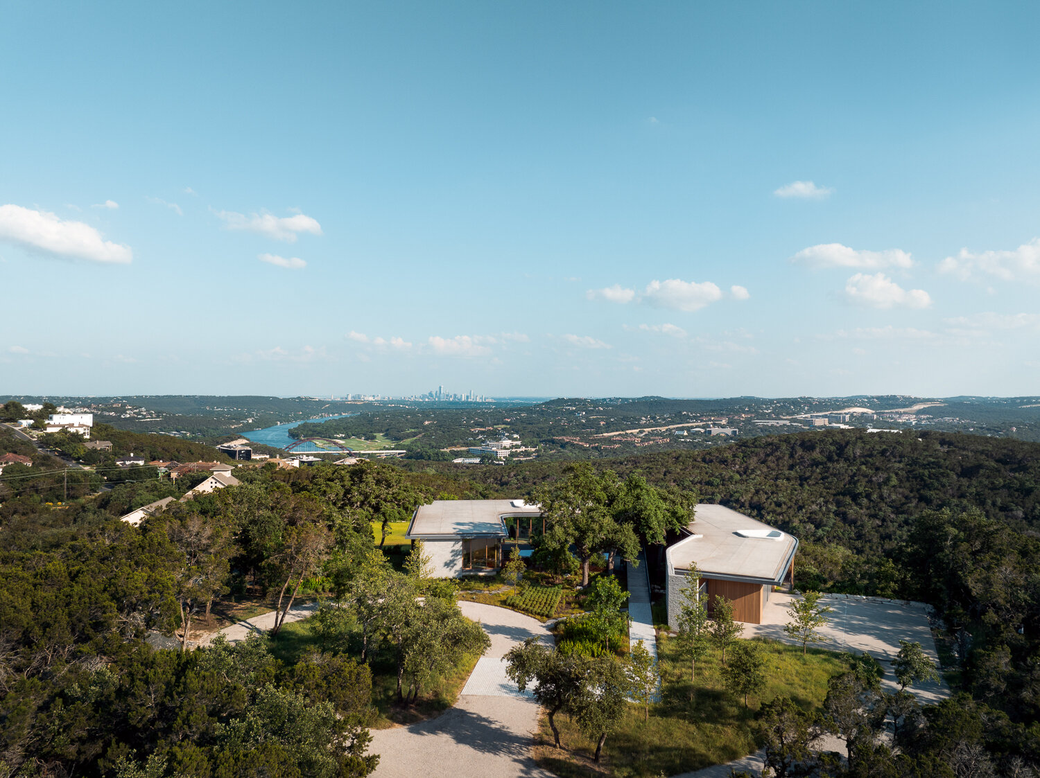 Natural stone, wood, and steel define this sustainable hillside home.