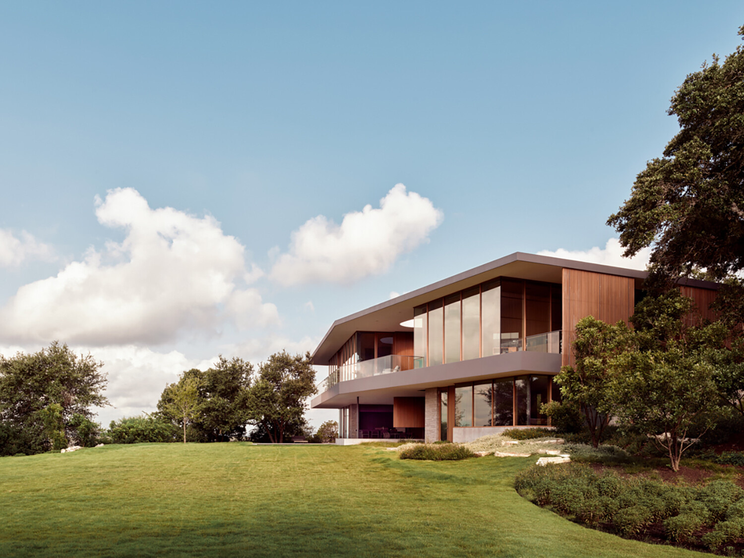 Natural stone, wood, and steel define this sustainable hillside home.