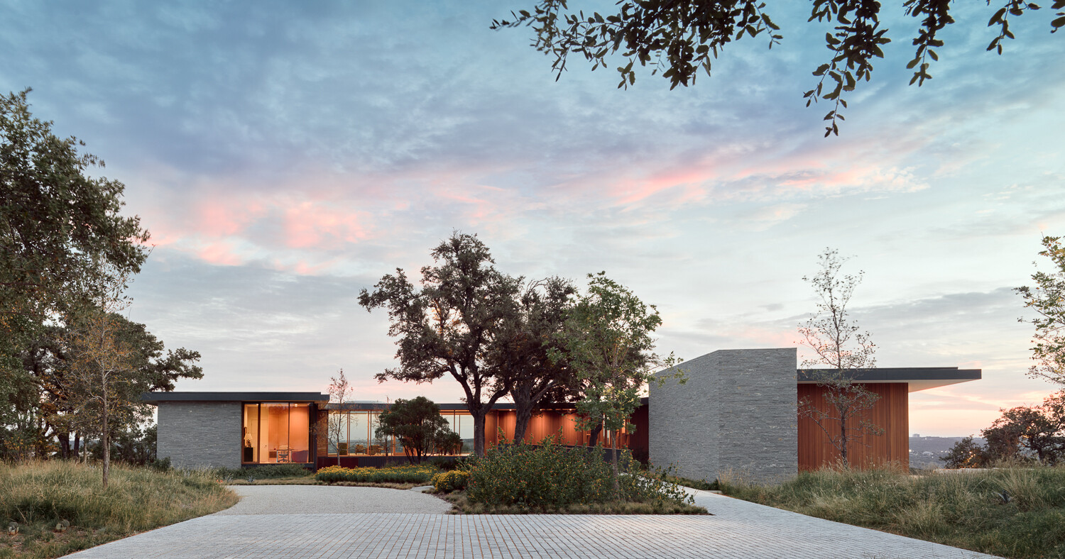Natural stone, wood, and steel define this sustainable hillside home.