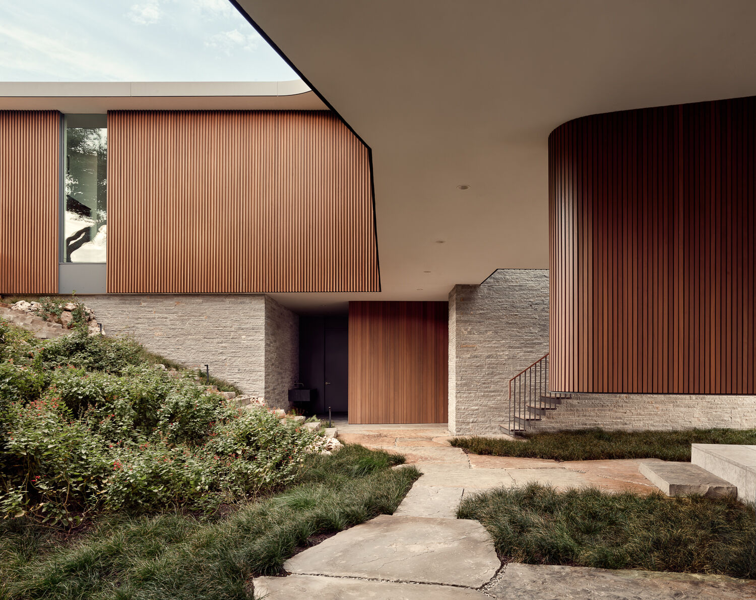 A breezy terrace leads to the pool, lawn, and expansive Austin views.