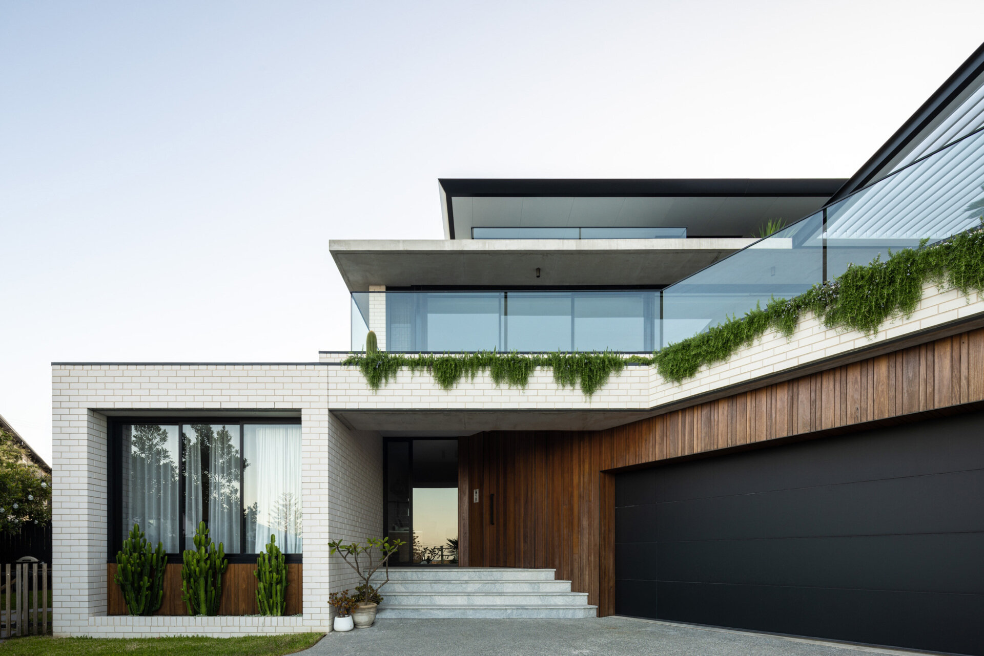Arrival to this modern home is via a lower-level entry that also houses a garage and generous utility and storage zones, practical and discreetly integrated into the base of the structure. From here, the home unfolds upward, revealing more of the view and more of its carefully layered design.