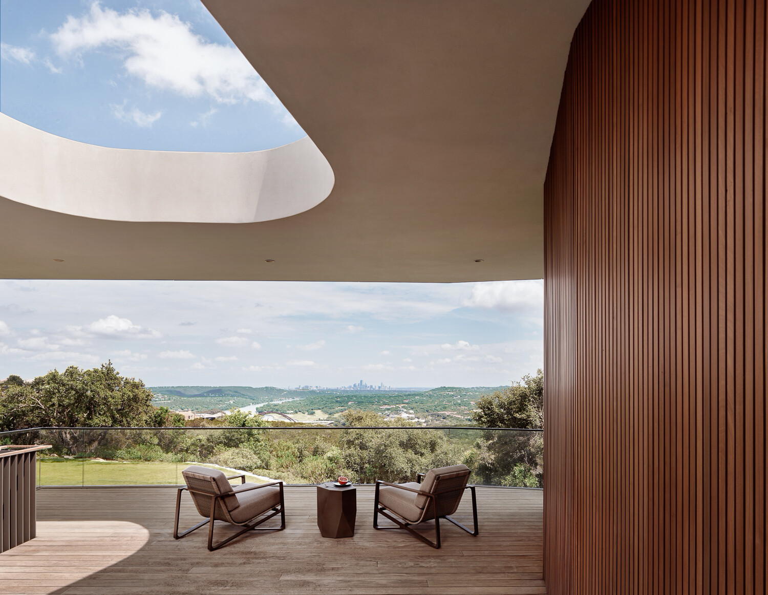 The balcony deck frames the panorama of Austin’s skyline and rolling hills.