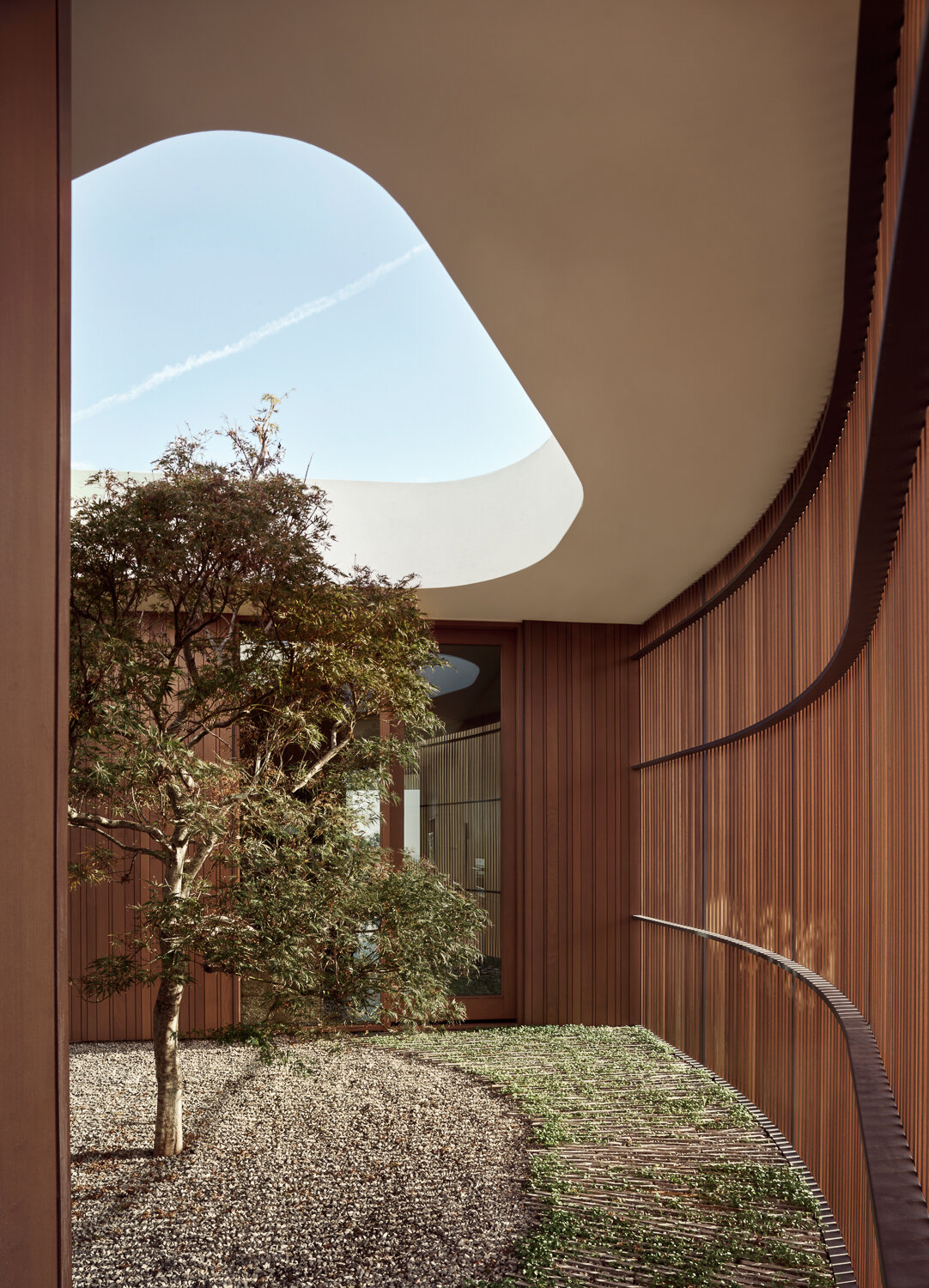 Sculptural apertures channel breezes and daylight through the home.