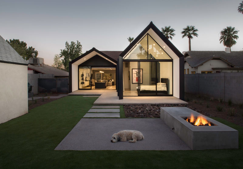 A striking 400-square-foot extension houses a new master suite with a clean gabled form clad in charcoal metal.