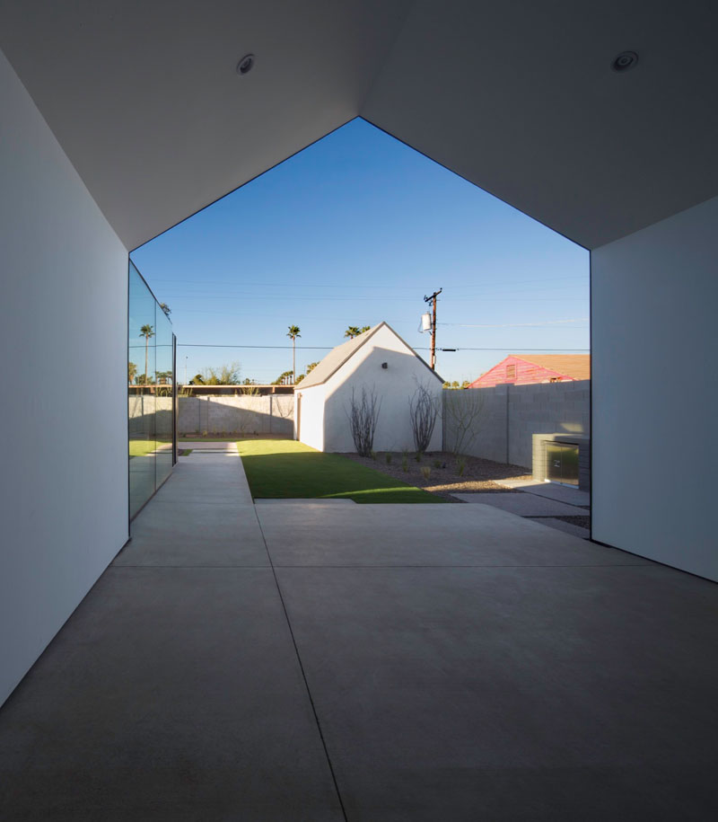 A covered patio flows off the living space, connecting the interior to the backyard with sliding glass doors and an open view.