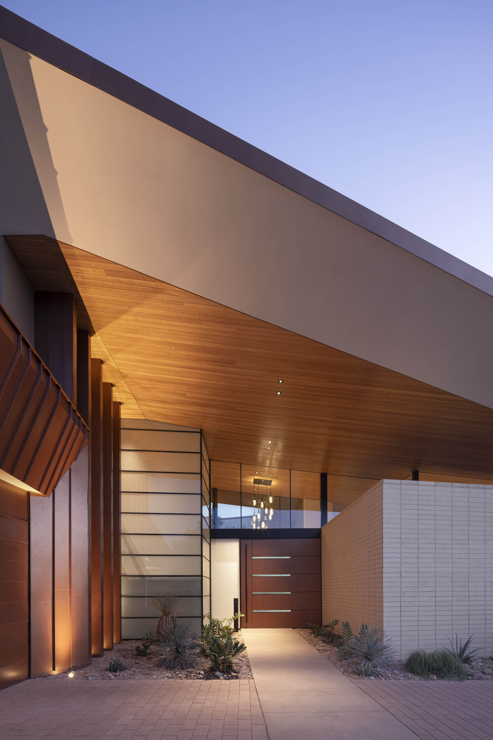 The monumental pivot door, measuring nearly 3 meters wide and over 3 meters tall, is both a robust barrier and a design statement.