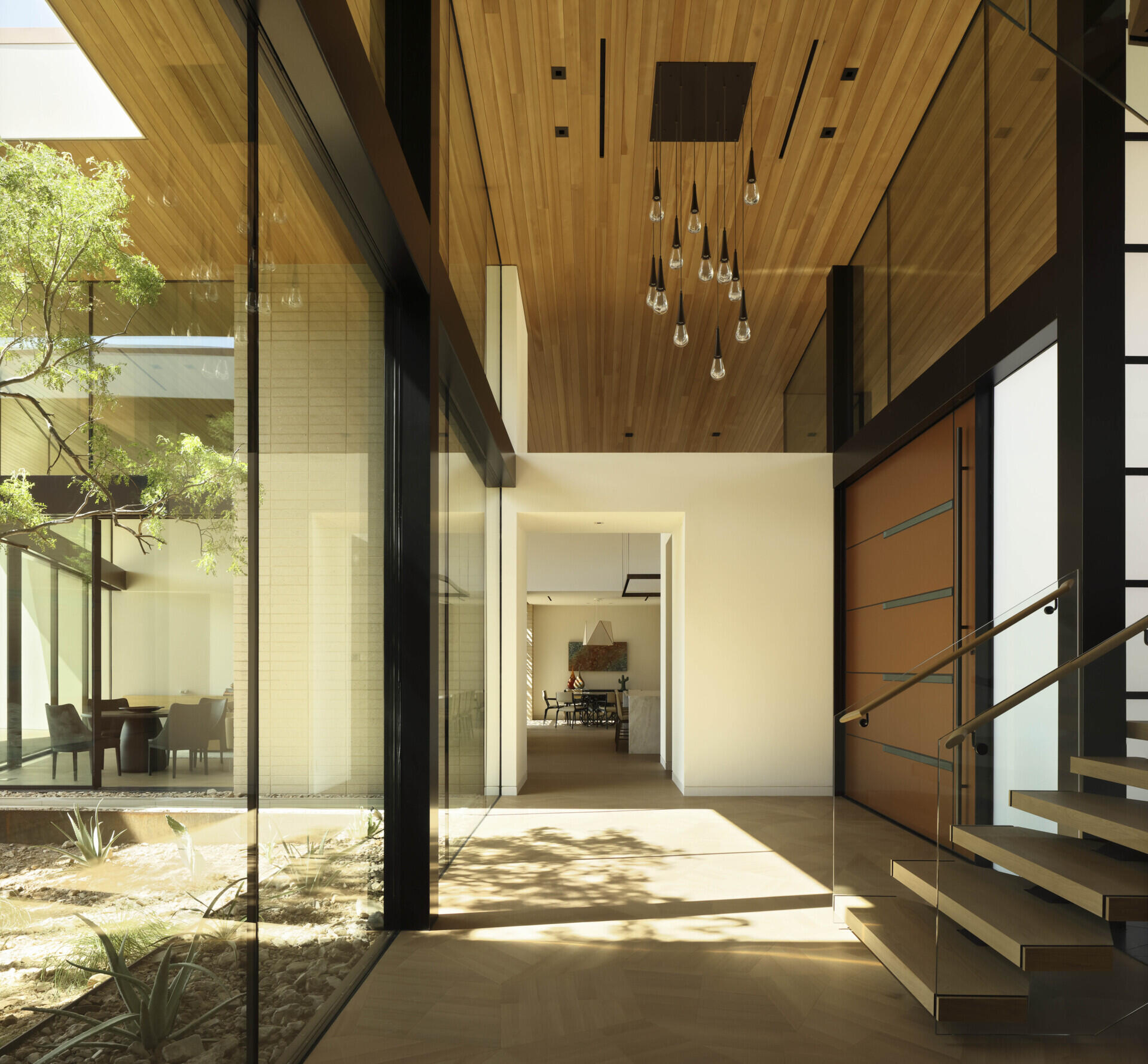 The monumental pivot door, measuring nearly 3 meters wide and over 3 meters tall, is both a robust barrier and a design statement.