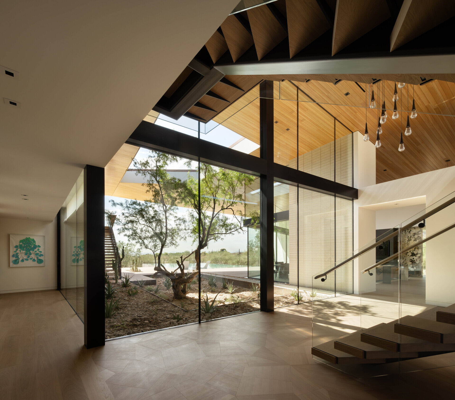 The monumental pivot door, measuring nearly 3 meters wide and over 3 meters tall, is both a robust barrier and a design statement.