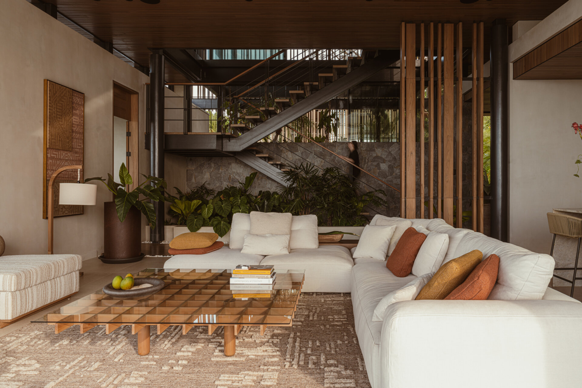 A floating stairwell becomes its own architectural moment. Suspended within a vertical garden, the stairs act as a quiet connector between levels while drawing attention to the surrounding vegetation. The stair's open design lets light pass through and continues the home’s lightness and spatial rhythm.