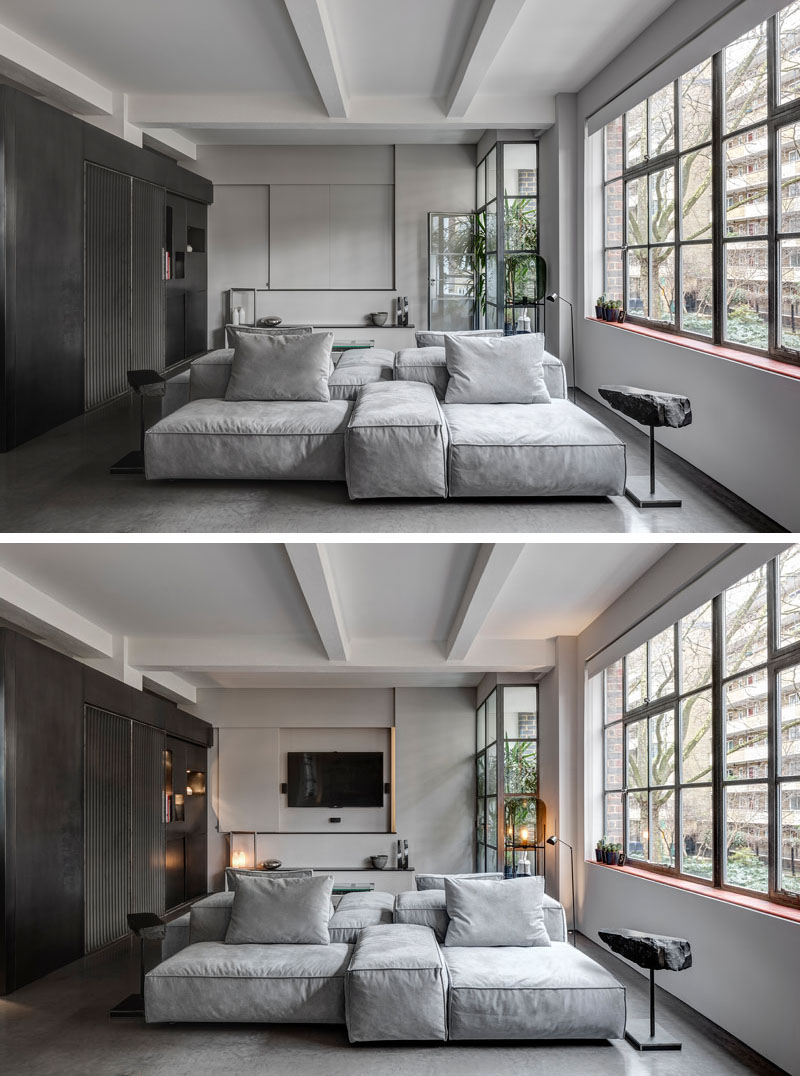In the living room, a key design element is the double-sided couch. One faces a hidden television, while the other looks toward the kitchen and dining space, reinforcing the apartment’s sense of choreographed movement.