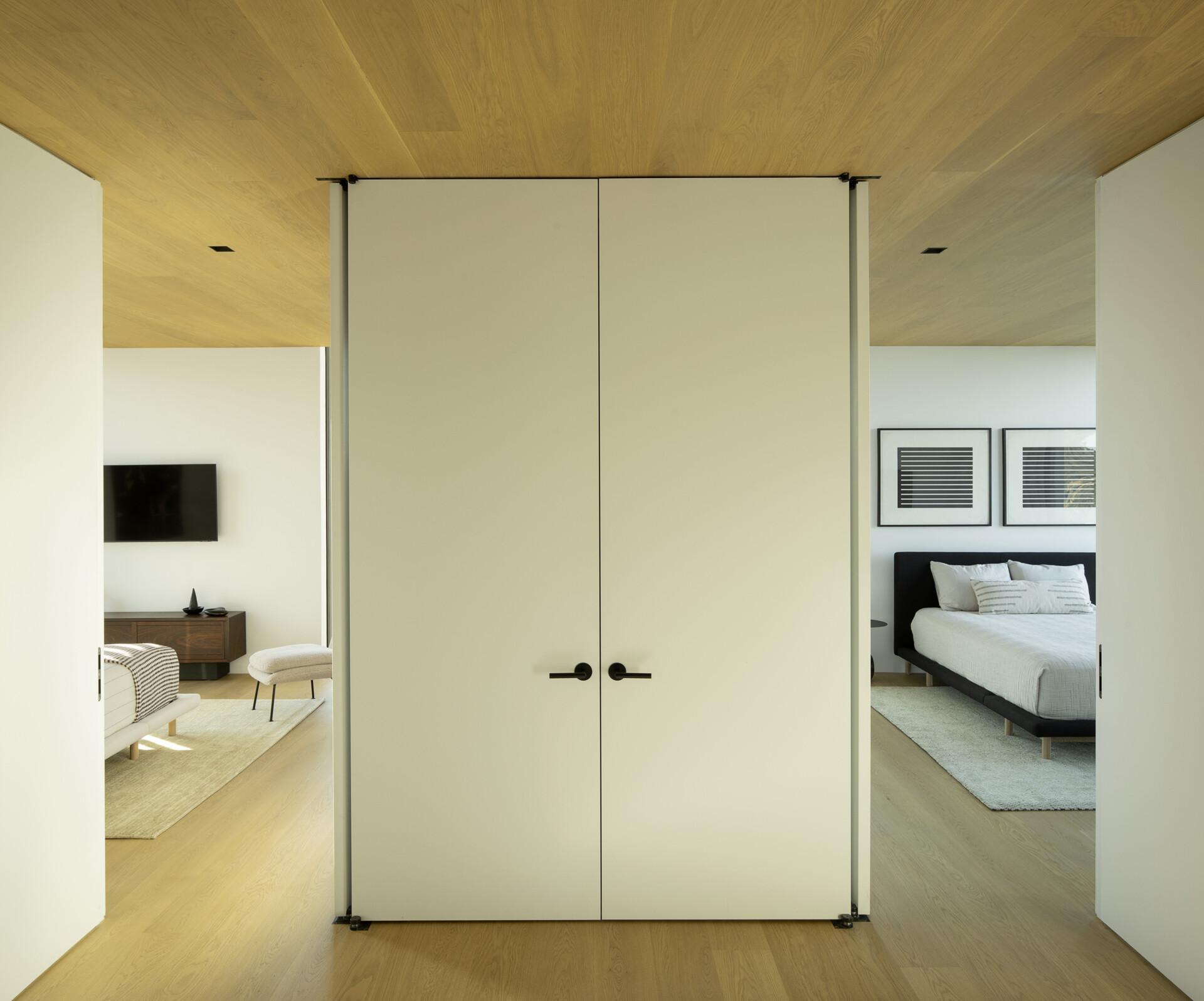 Two guest rooms share the upper level, positioned for comfort and privacy while benefiting from the home’s layered views and abundant natural light.