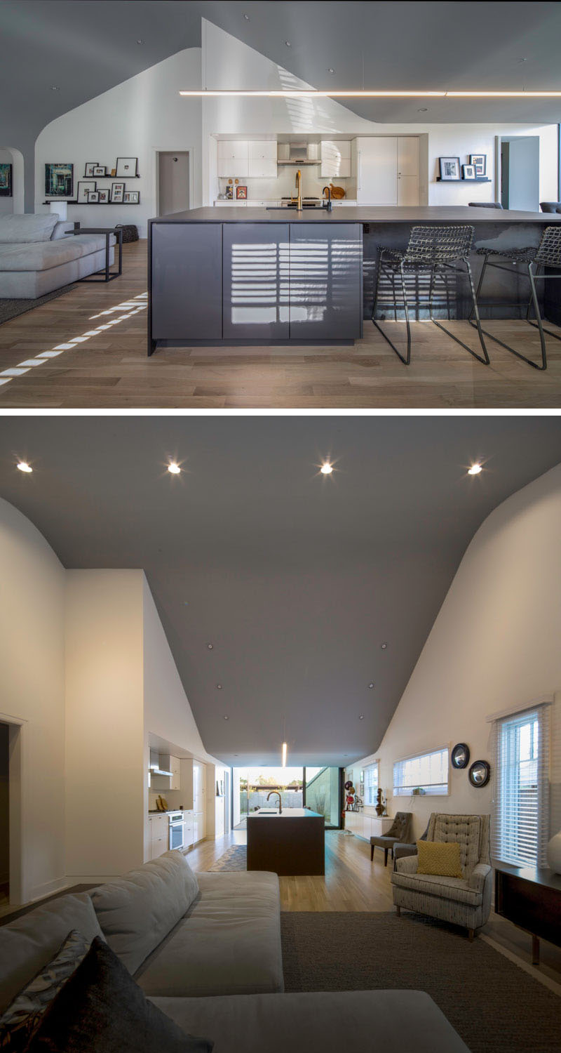 Walls were removed to turn a maze of small rooms into a bright, open-plan living, dining, and kitchen area with vaulted ceilings.