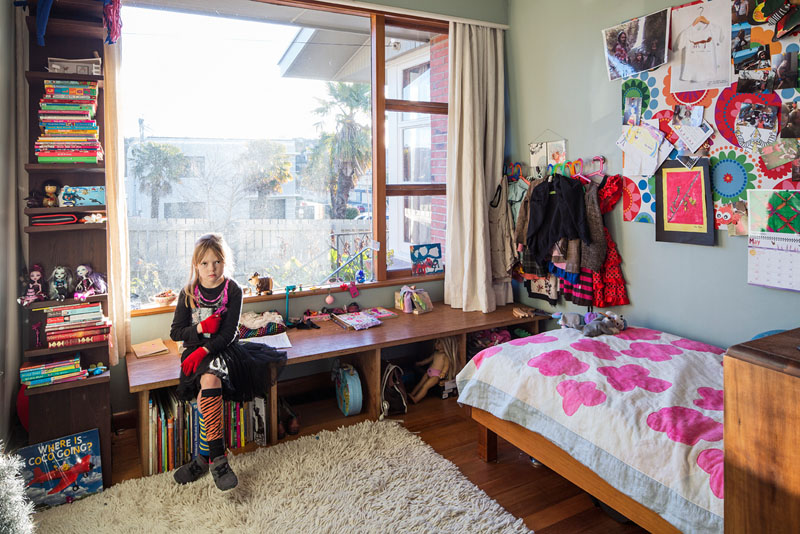 A window bench in a child's bedrooms doubles as storage nooks.