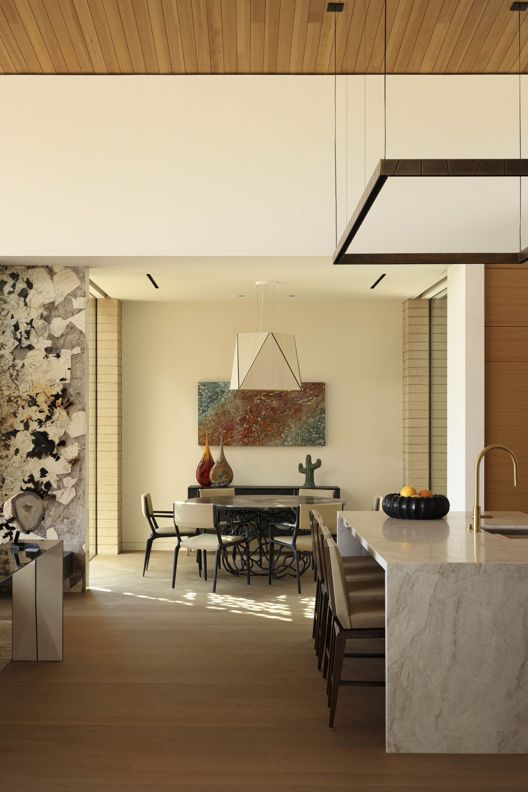 Intimate dining areas are strategically placed to connect with both indoor and outdoor environments. The interplay of light through patterned screens adds texture to mealtime settings.