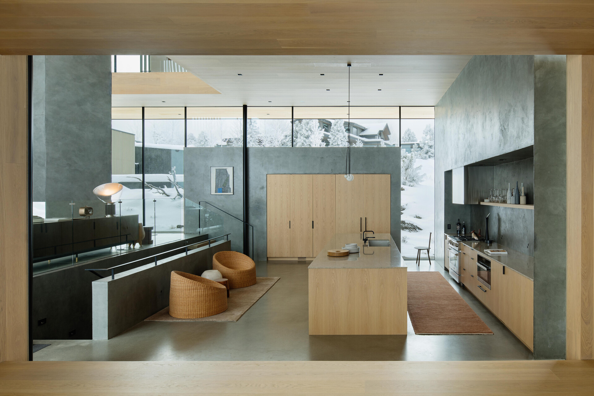 Located on its own platform, the kitchen serves as both a functional hub and a social gathering point. Its open positioning allows it to flow into adjacent living areas while still offering moments of privacy within the home’s sculptural form.