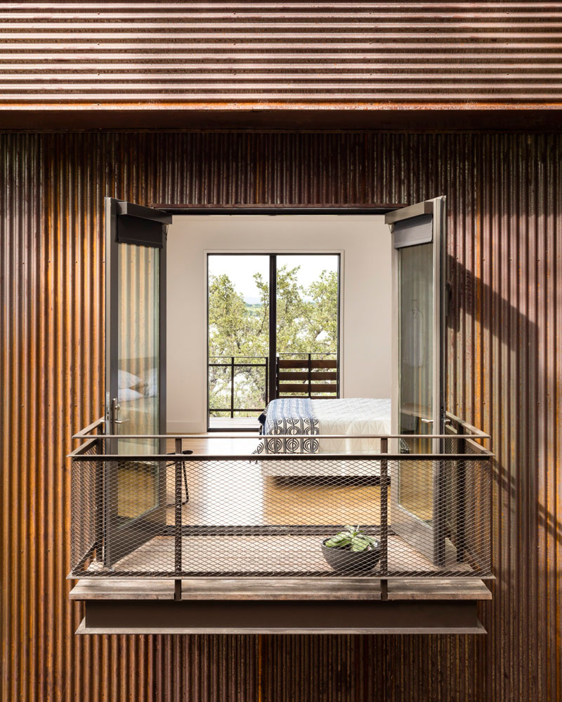 A modern bedroom with a small walk-out balcony.
