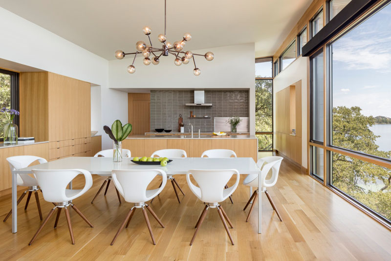 An inviting dining room with a sculptural pendant lamp and open lake views.