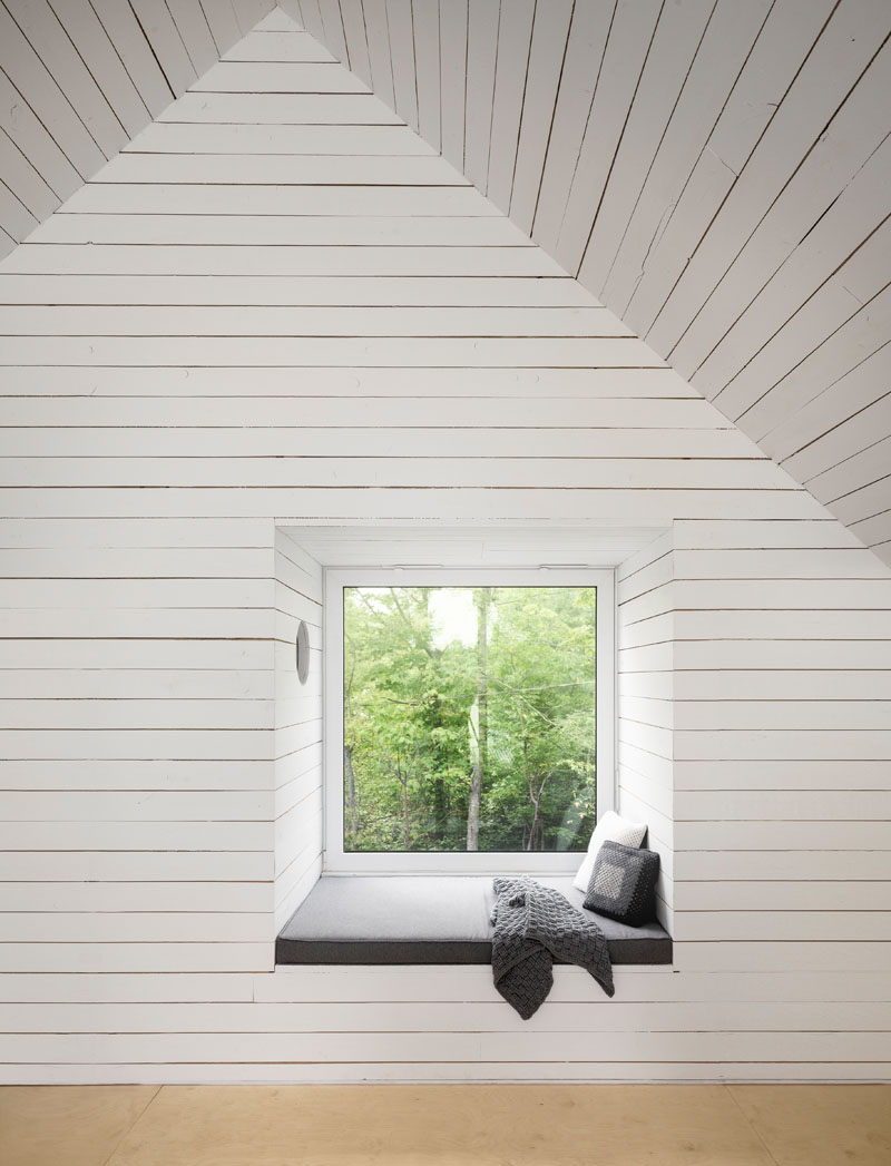A recessed window seat in a modern lakeside chalet.