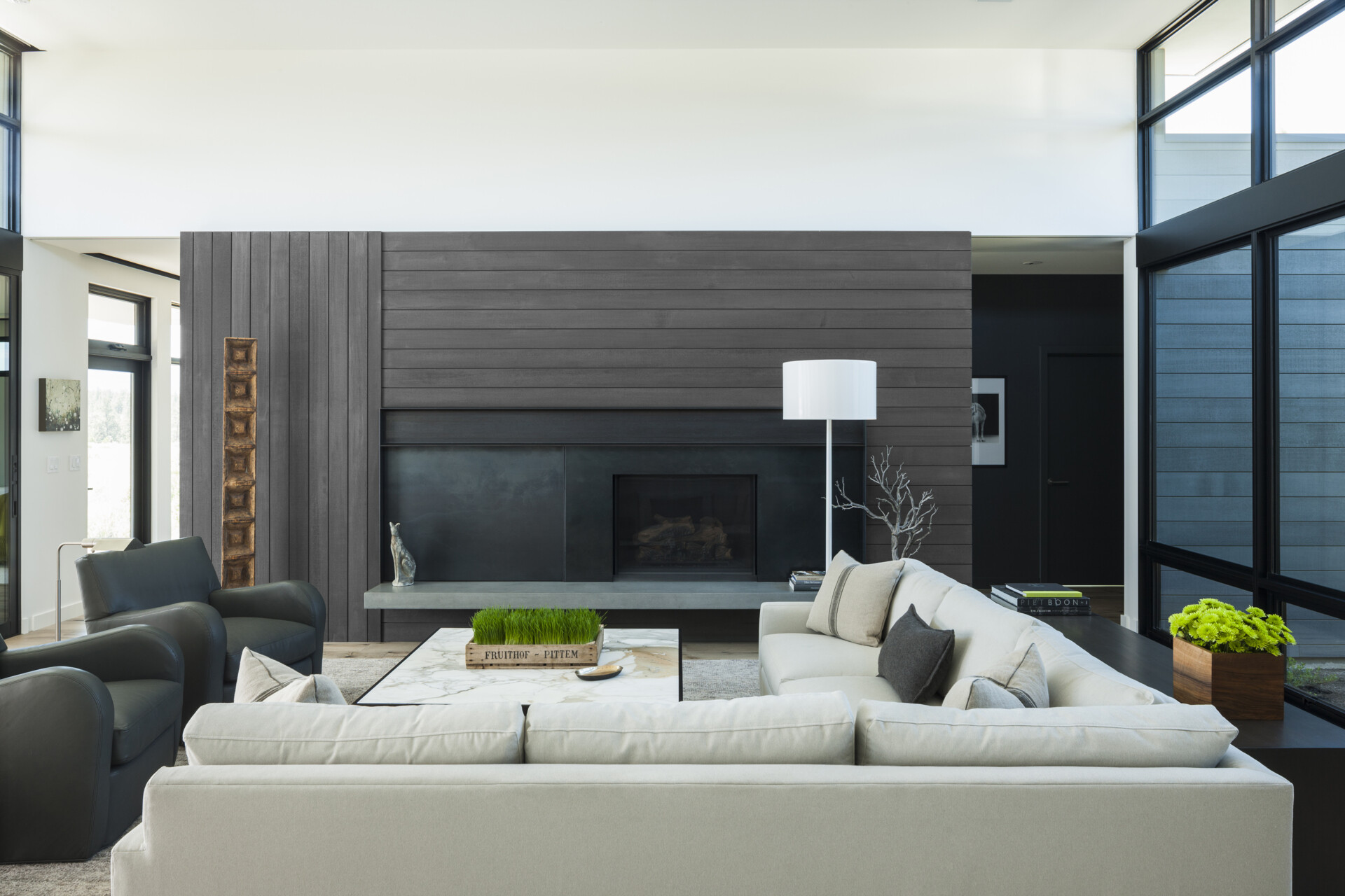 The living area is bright and expansive, yet completely adaptable thanks to a clever cabinet wall. Five sliding panels conceal or reveal a fireplace, TV, storage, and even parts of the bedroom suite.
