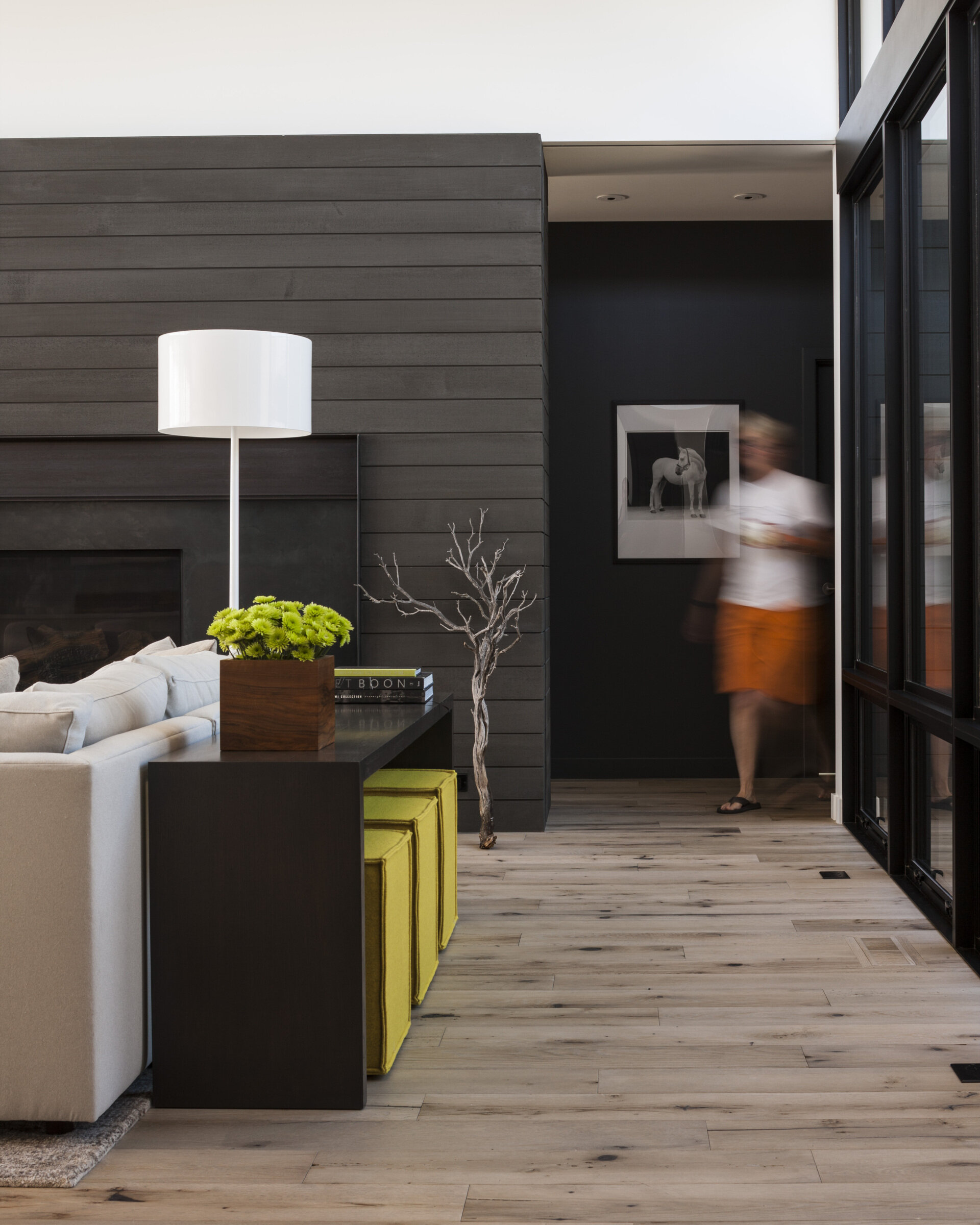 The living area is bright and expansive, yet completely adaptable thanks to a clever cabinet wall. Five sliding panels conceal or reveal a fireplace, TV, storage, and even parts of the bedroom suite.