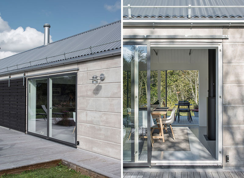 Sliding barn doors protect the windows of this sleek concrete house while adding a rustic, architectural detail.